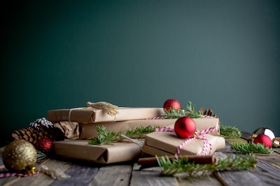 An image showcasing a beautifully decorated Christmas tree with various advent calendars underneath, displaying a mix of traditional and creative designs